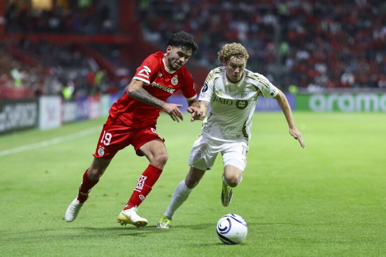 Santiago Simon of Toluca fights for the ball with Jacob Shaffelburg of Los Angeles FC