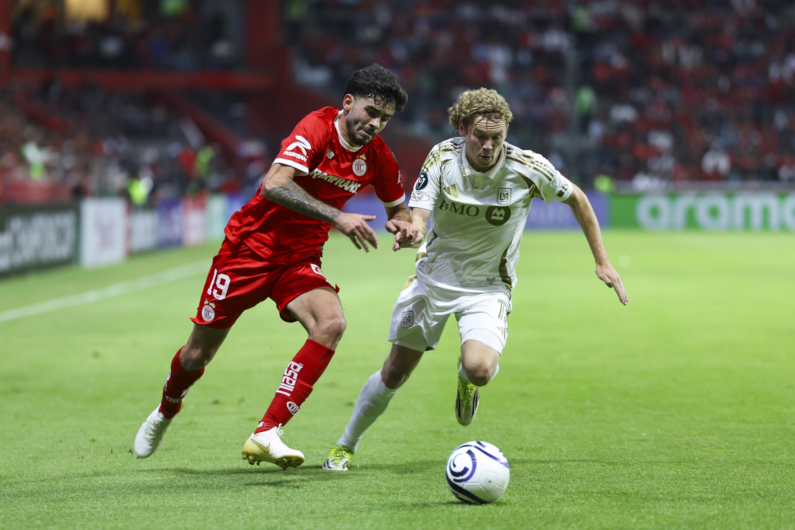 Santiago Simon of Toluca fights for the ball with Jacob Shaffelburg of Los Angeles FC